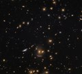 In SDSS J0952+3434, the lower arc-shaped galaxy has the characteristic shape of a galaxy that has been gravitationally lensed.[51]
