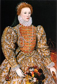 Woman, facing left, with a tiara on red-coloured hair, wearing voluminous and heavily decorated clothing with large sleeves, tight waist and a ruff round the neck. A crown on a table is visible in the background