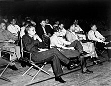 A crowd seated in folding chairs